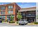 An exterior view of a brick building with multiple businesses on the ground floor at 6455 Darely Ct, Cumming, GA 30040