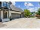 Beautiful home exterior with a driveway and three-car garage at 6455 Darely Ct, Cumming, GA 30040
