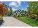 Beautiful home featuring a long driveway, lush landscaping, and manicured lawn at 6455 Darely Ct, Cumming, GA 30040
