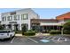 An outdoor shot of a commercial building with retail spaces and visible parking at 6455 Darely Ct, Cumming, GA 30040