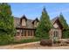 An exterior shot of a building with a wooden facade and well-manicured landscaping at 6455 Darely Ct, Cumming, GA 30040
