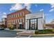 A commercial building's front view with multiple businesses and available parking spots at 6455 Darely Ct, Cumming, GA 30040