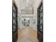 Grand foyer featuring high ceilings, hardwood floors, iron work doors, and an open staircase at 6455 Darely Ct, Cumming, GA 30040