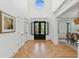 Spacious foyer with hardwood floors, high ceilings, and decorative doors leading to the dining room at 6455 Darely Ct, Cumming, GA 30040