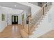 Bright foyer with hardwood floors, modern staircase with iron railings, and a view to the entryway at 6455 Darely Ct, Cumming, GA 30040