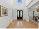 Spacious foyer with hardwood floors, high ceilings, and decorative doors leading to the dining room at 6455 Darely Ct, Cumming, GA 30040