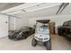 Three-car garage with a golf cart and sportscar at 6455 Darely Ct, Cumming, GA 30040
