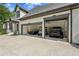 Spacious three-car garage with ample storage space for vehicles and equipment at 6455 Darely Ct, Cumming, GA 30040