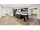 Open kitchen and living area with large kitchen island with marble countertop at 6455 Darely Ct, Cumming, GA 30040