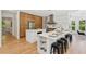 Modern kitchen with an island, breakfast bar, stainless steel appliances, and hardwood floors at 6455 Darely Ct, Cumming, GA 30040