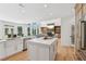Bright, open kitchen featuring a large island, farmhouse sink, modern appliances, and hardwood floors at 6455 Darely Ct, Cumming, GA 30040