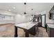 Kitchen with large island, stainless steel appliances and adjoining living area at 6455 Darely Ct, Cumming, GA 30040