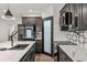 Modern kitchen with stainless steel appliances, a sink, and marble countertops at 6455 Darely Ct, Cumming, GA 30040
