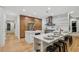 A modern, spacious kitchen with stainless steel appliances, beautiful hardwood floors, and an island with bar stool seating at 6455 Darely Ct, Cumming, GA 30040