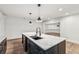 The large marble countertop island with dark wood cabinets provides both function and style at 6455 Darely Ct, Cumming, GA 30040