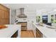 Well-equipped kitchen featuring stainless steel appliances, custom cabinetry, and a breakfast bar at 6455 Darely Ct, Cumming, GA 30040