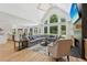 Bright living room features cathedral ceilings, fireplace, and seamlessly connects to the kitchen and dining areas at 6455 Darely Ct, Cumming, GA 30040