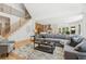 Open-concept living room with staircase, seamlessly connecting to a modern kitchen and inviting living spaces at 6455 Darely Ct, Cumming, GA 30040