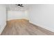 Spacious living room with wood-look floors and modern ceiling fan at 6455 Darely Ct, Cumming, GA 30040