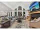 Spacious living room with high ceilings, fireplace, hardwood floors, and abundant natural light at 6455 Darely Ct, Cumming, GA 30040