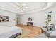 Bright main bedroom features tray ceilings, seating area, and hardwood floors at 6455 Darely Ct, Cumming, GA 30040