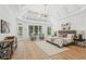 Bright main bedroom features tray ceilings, seating area, and hardwood floors at 6455 Darely Ct, Cumming, GA 30040