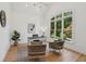 Bright office space featuring hardwood floors, natural light, and a modern desk at 6455 Darely Ct, Cumming, GA 30040