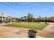 Exterior of a building with a green lawn, patio, string lights, and outdoor seating under a blue sky at 6455 Darely Ct, Cumming, GA 30040