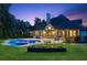 Stunning backyard pool and spa with lush landscaping and elegant architecture at 6455 Darely Ct, Cumming, GA 30040