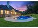 Stunning backyard pool and spa with lush landscaping and elegant architecture at 6455 Darely Ct, Cumming, GA 30040
