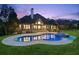 Stunning backyard pool and spa with lush landscaping and elegant architecture at 6455 Darely Ct, Cumming, GA 30040