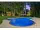 Inviting pool with surrounding mature trees and manicured lawn in backyard at 6455 Darely Ct, Cumming, GA 30040