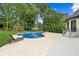 Inviting kidney-shaped pool with an attached spa surrounded by lush landscaping and a sun-lounging patio at 6455 Darely Ct, Cumming, GA 30040