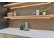 Close-up of modern shelving with decorative items and integrated lighting, adding a touch of elegance at 6455 Darely Ct, Cumming, GA 30040