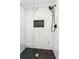 Shower showcasing marble walls, black hardware, and a black-tiled floor at 6455 Darely Ct, Cumming, GA 30040
