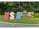 Westchester Polo Golf & Country Club entrance sign with USA decorations and landscaping at 6455 Darely Ct, Cumming, GA 30040