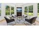 Cozy sitting room with a fireplace, TV, and backyard views at 6455 Darely Ct, Cumming, GA 30040