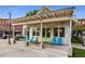 Charming storefront with blue and green accents, and outdoor seating, in a bustling area with mature trees at 6455 Darely Ct, Cumming, GA 30040