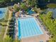 Large swimming pool with lounge chairs, umbrellas, slide, and manicured landscaping at 6455 Darely Ct, Cumming, GA 30040