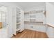 Large walk-in closet with custom shelving and adjacent to a modern bathroom at 6455 Darely Ct, Cumming, GA 30040