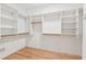 Spacious walk-in closet with custom shelving and wood floors at 6455 Darely Ct, Cumming, GA 30040