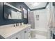 Nicely updated bathroom with marble vanity top, shower and dark blue accent wall at 1101 Collier Nw Rd # K5, Atlanta, GA 30318