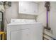 Functional laundry room with washer, dryer, and storage cabinets at 1101 Collier Nw Rd # K5, Atlanta, GA 30318