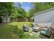 Backyard patio with cushioned seating, a shed and a large grassy yard, perfect for outdoor relaxation at 1477 Spruce Dr, Smyrna, GA 30080