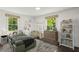 Well-lit bedroom featuring charming decorations, neutral tones, and a window view of the yard at 1477 Spruce Dr, Smyrna, GA 30080