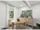 Bright dining area with round table, artwork, and view to the front yard at 1477 Spruce Dr, Smyrna, GA 30080