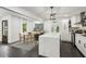 Bright kitchen and dining area offers white cabinets, stainless appliances, and a view to the backyard at 1477 Spruce Dr, Smyrna, GA 30080