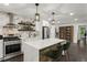 Modern kitchen features an island with seating, white cabinets, stainless steel appliances, and open shelving at 1477 Spruce Dr, Smyrna, GA 30080