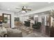 Open-concept living room featuring stylish furniture, a ceiling fan, and seamless flow into the dining and kitchen areas at 1477 Spruce Dr, Smyrna, GA 30080