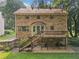 Brick home with a large deck, spacious backyard, and access stairs at 786 Mitsy Pt, Marietta, GA 30068